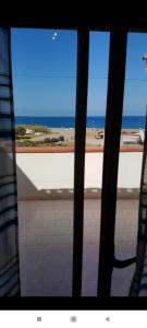a room with a view of the ocean from a window at Casa Vacanza via Annarita Sidoti in Porto San Giorgio