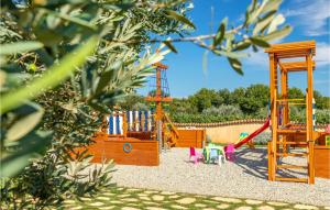 a playground with a slide and a swing set at Beautiful Home In Valtura With House A Panoramic View in Valtura