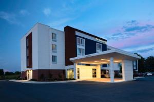 a large building with a lit up front at SpringHill Suites Winchester in Winchester