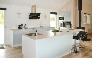 a white kitchen with a sink and a counter at Stunning Home In Henne With Indoor Swimming Pool in Henne Strand