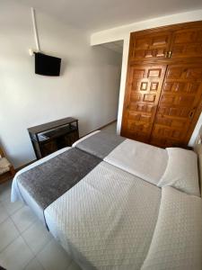 Posteľ alebo postele v izbe v ubytovaní Hotel Simón