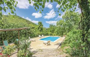 a swimming pool with two chairs next to a mountain at Poggio Miletto in Pratella