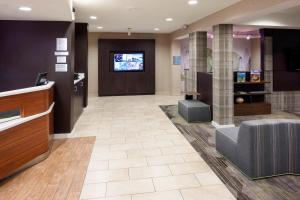 a lobby with a tv and a waiting room at Courtyard by Marriott Pensacola in Pensacola
