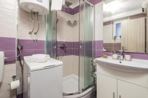 a bathroom with a sink and a shower at Main View Apartment in Rijeka