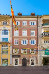 a kite is flying in front of a building at Main View Apartment in Rijeka