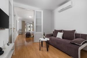 ein Wohnzimmer mit einem Sofa und einem Tisch in der Unterkunft Main View Apartment in Rijeka