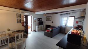 a living room with a couch and a table at Casas da Biquinha in Sintra