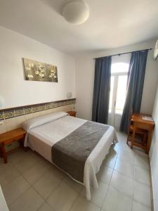 Posteľ alebo postele v izbe v ubytovaní Hotel Simón
