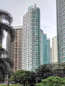 a tall building with many windows in a city at Spacious BGC 2 BR with a view in Manila