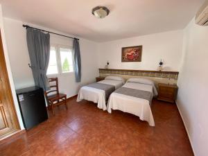 Posteľ alebo postele v izbe v ubytovaní Hotel Simón