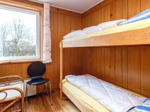 a bedroom with two bunk beds and a window at Holiday home Hesselager VII in Hesselager