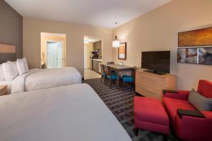 a hotel room with two beds and a flat screen tv at TownePlace Suites by Marriott Ottawa Kanata in Ottawa