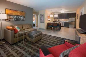 a living room with a couch and a kitchen at TownePlace Suites by Marriott Ottawa Kanata in Ottawa