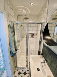 a bathroom with a shower and a sink at The Green Room guest suite in Belfast