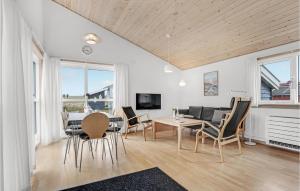 comedor y sala de estar con mesa y sillas en R Golfferiehuse, en Rø