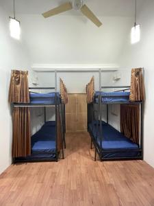two bunk beds in a room with a ceiling fan at Gorga hostel in Yogyakarta +36 photos