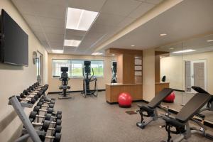 a gym with chairs and a table and a desk at TownePlace Suites by Marriott Milwaukee Grafton in Grafton