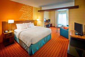 a hotel room with a bed and a television at Fairfield Inn and Suites by Marriott Monaca in Monaca