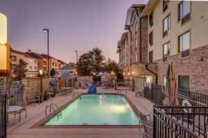 a swimming pool in a courtyard with a building at TownePlace Suites by Marriott Monroe in Monroe