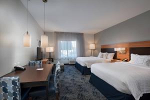 Una habitación de hotel con dos camas y un escritorio. en TownePlace Suites by Marriott Monroe, en Monroe