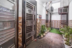 un couloir avec des plantes en pots dans un bâtiment dans l'établissement Homlee Villa Apartment with kitchen in East Delhi- Ghaziabad, à Ghaziabad