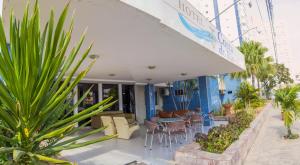 a patio of a hotel with chairs and plants at Costa do Rio Hotel in Petrolina