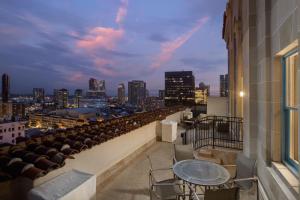 a balcony with tables and chairs and a view of the city at Courtyard by Marriott San Diego Downtown in San Diego