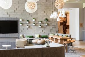 a living room with a couch and a table at Element Scottsdale at SkySong in Scottsdale