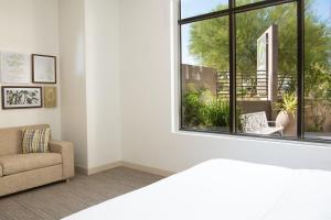 a living room with a couch and a window at Element Scottsdale at SkySong in Scottsdale