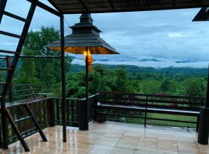 a lamp on a balcony with a view of the mountains at Phingboon in Saluang