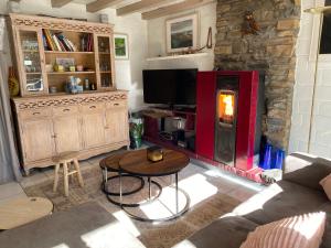 a living room with a couch and a table and a fireplace at Domaine du Bonsoy--Azur in Blaimont