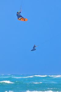 a person on a kite flying over the ocean at Sunrise B&B in Huxi