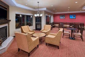 a waiting room with chairs and a fireplace at TownePlace Suites by Marriott Albuquerque North in Albuquerque