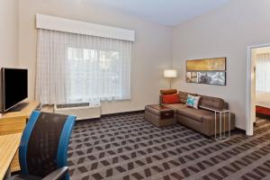 a living room with a couch and a tv at TownePlace Suites by Marriott Montgomery EastChase in Montgomery