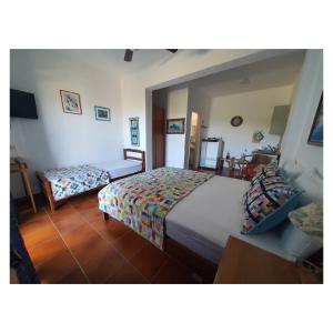 a bedroom with two beds and a table at Sartivista Bed & Breakfast in Sarti