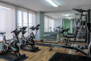 a gym with treadmills and elliptical machines at AC Hotel Guadalajara by Marriott, Spain in Guadalajara