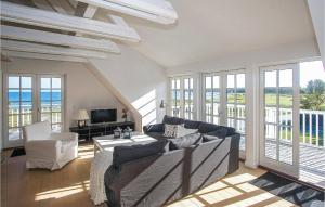 un soggiorno con divano, TV e finestre di Pet Friendly Apartment In Nykbing Sj With Wifi a Højby