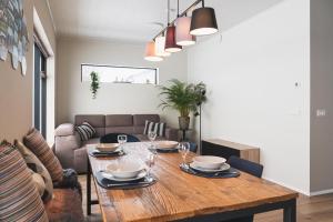 a living room with a wooden table and a couch at Skidbakki Guesthouse 