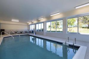 a large swimming pool in a building with windows at TownePlace Suites by Marriott Brentwood in Brentwood