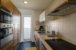 a kitchen with a sink and a stove top oven at apartment with amazing sea view in Burgau