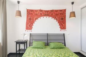 a bedroom with a bed and an arch above it at apartment with amazing sea view in Burgau