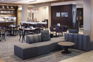 a lobby with a couch and tables and chairs at Courtyard Phoenix Chandler/Fashion Center in Chandler