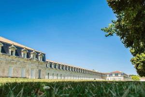 a large building with grass in front of it at gite des huskys in Tonnay-Charente