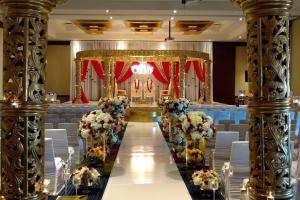 a banquet hall with white chairs and a altar with flowers at Courtyard by Marriott Dallas Plano/The Colony in The Colony