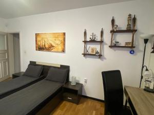 a bedroom with a bed and a painting on the wall at Apartament Bogoslovovi in Varna City