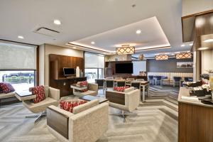 a lobby with couches and chairs and a bar at TownePlace Suites by Marriott Dover Rockaway in Dover