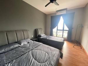 a bedroom with two beds and a window with a ceiling fan at Paradigm Mall Johor Bahru The Platino 3 Bedroom in Johor Bahru +13 photos