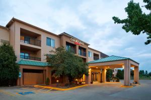 a hotel with a parking lot in front of it at Courtyard by Marriott Springfield in Springfield