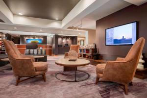 a waiting room with chairs and a flat screen tv at Courtyard by Marriott Springfield in Springfield