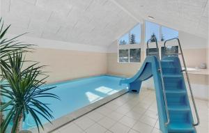 a swimming pool with a slide in a house at Cozy Home In Vig With Kitchen in Vig +33 photos